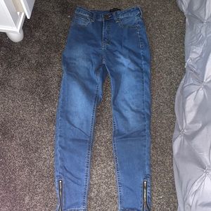 medium wash jeans with accent zipper on the ankle